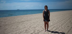 girl in dress on fort lauderdale beach sandy blue sky
