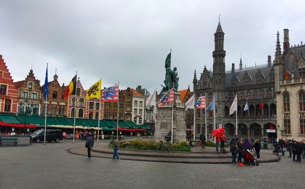 bruges belgium town square flags gothic