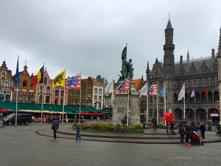 bruges belgium town square flags gothic