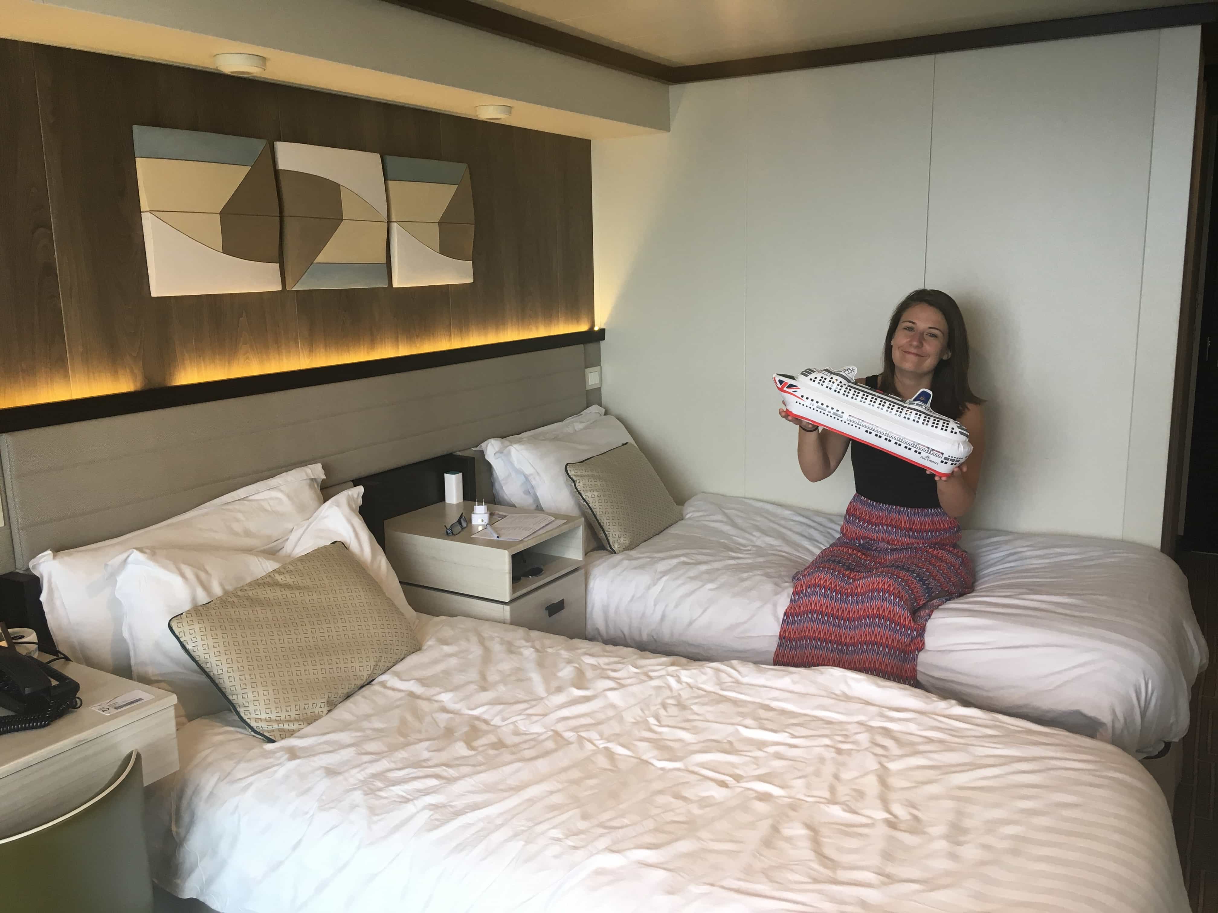 p&o britannia balcony cabin reviews review woman sat on bed with inflatable cruise ship 