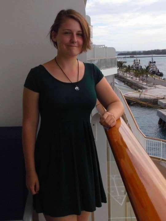 Norwegian Breakaway Dinner Dress Code Girl on Balcony in Green Dress