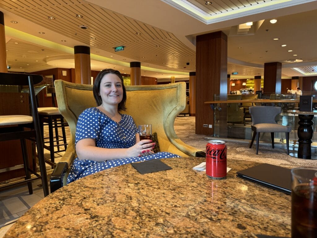 Emma cruises Celebrity Infinity, drink in a bar