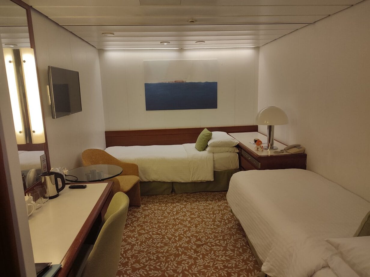 Inside cabin with fixed twin beds on Balmoral.